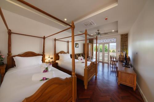 Ліжко або ліжка в номері Lanna Inthan Resort