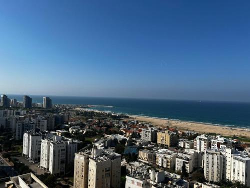 an aerial view of a city and the ocean at apartments with separate kitchen by the sea in Ashdod