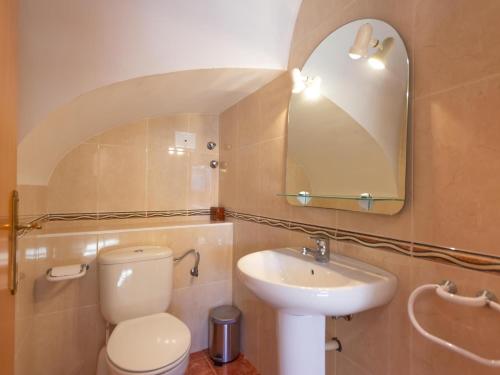 a bathroom with a toilet and a sink and a mirror at INNOUTHOME CASA CON PISCINA Av AMETLLA DE MAR in L'Ametlla de Mar