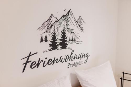 a bedroom with a mountain sticker on the wall at Freigeist in Nesselwang