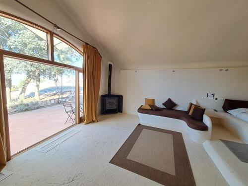 a living room with a white couch and a large window at Hotel Rural & Spa Las Nubes in Albalate de Zorita