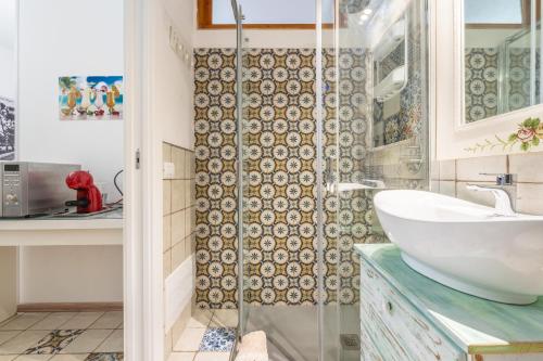 a bathroom with a sink and a shower at Alla Marina Monolocale Deluxe in Cagliari
