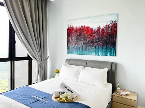 a bedroom with a bed with a painting on the wall at D'pristine by Antlerzone in Johor Bahru