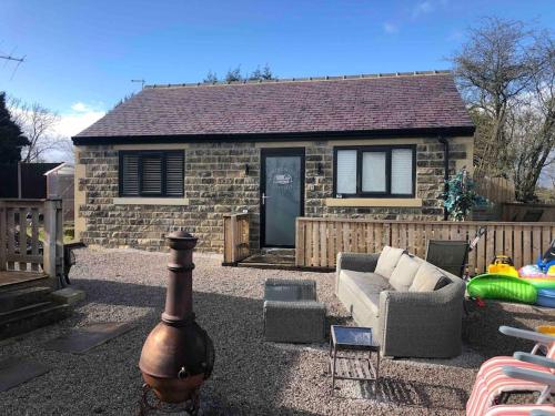 a brick house with a couch in front of it at Springwood farm in Kirkhamgate