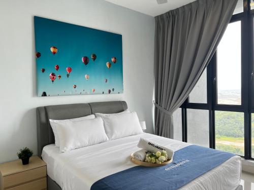 a bedroom with a bed with a blue painting on the wall at D'pristine by Antlerzone in Johor Bahru