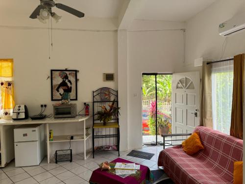 a living room with a couch and a table at Diamondview in Soufrière