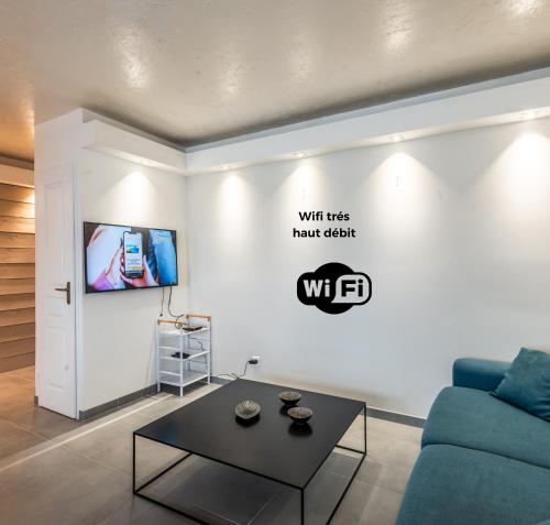 a living room with a couch and a table at Appart T2 I Moderne I St Julien in Saint-Julien-en-Genevois