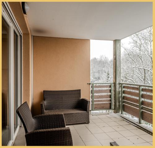 a living room with two chairs and a balcony at Appart T2 I Moderne I St Julien in Saint-Julien-en-Genevois