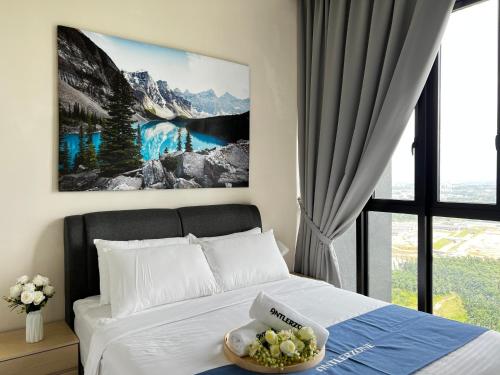 a bedroom with a bed with a bowl of grapes on it at D'pristine by Antlerzone in Johor Bahru