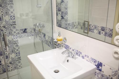 a bathroom with a white sink and a shower at Vinařský dům Mařatice in Uherské Hradiště
