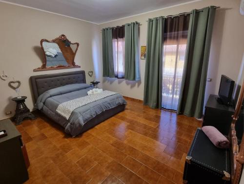 a bedroom with a bed and a mirror on the wall at VintageCo. Apartments in Motta SantʼAnastasia