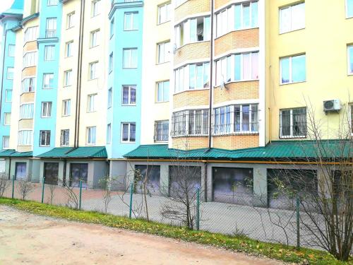 a tall building with a fence in front of it at НОВОБУДОВА 2 кімнати Вернадського 8 in Lviv