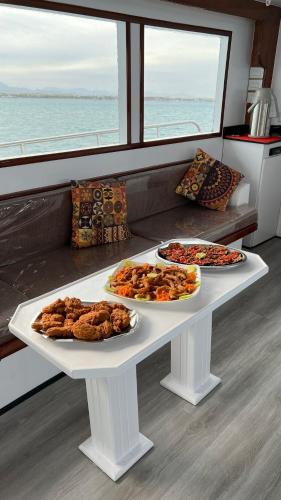 a table with three plates of food on a boat at Edan Storm Yacht in Hurghada