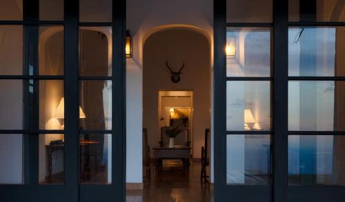 a hallway with doors and a room with a table at Thotalagala in Haputale