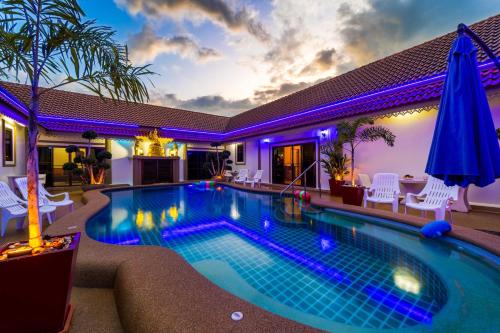 a swimming pool in a house with purple lights at Siam Court Hotel and Resort in Bang Sare