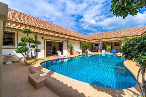 a swimming pool in the backyard of a house at Siam Court Hotel and Resort in Bang Sare