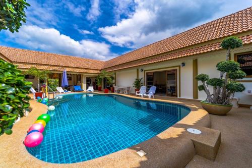 a swimming pool in the backyard of a house at Siam Court Hotel and Resort in Bang Sare