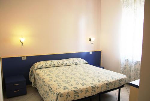 Postel nebo postele na pokoji v ubytování Albergo La Mimosa