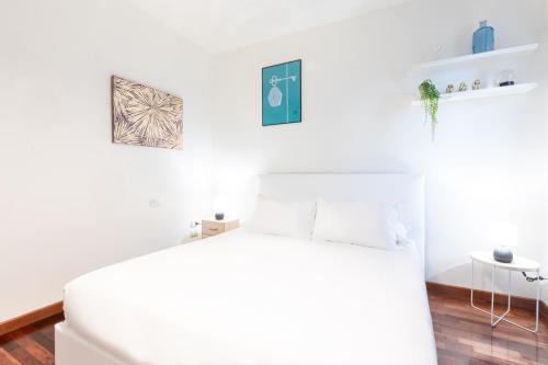 een witte slaapkamer met een bed en een tafel bij Bicocca Terrace Two Bedroom Apartment -Top Collection in Milaan