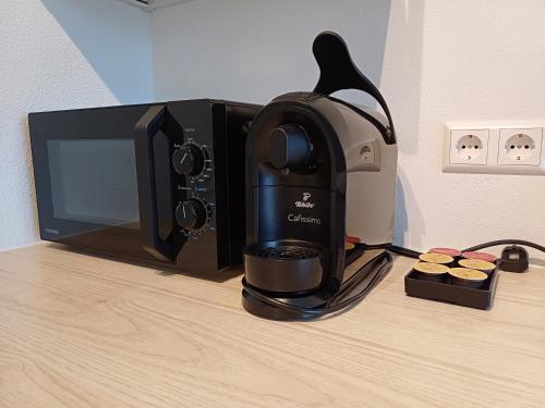 a coffee maker is sitting next to a microwave at Bude 23 - Ferienwohnung Aalen in Aalen