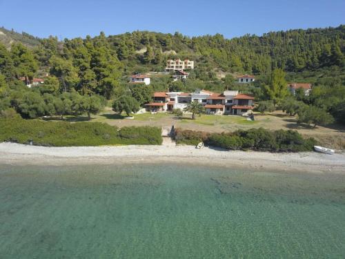 an aerial view of a house on a beach at Acqua Blue Mola Kaliva resort in Mola Kalyva