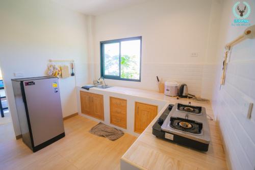 a kitchen with a stove and a sink in it at Espano 1 in Ban Tha Chang