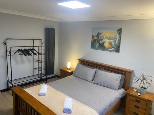 a bedroom with a bed and a picture on the wall at Pinchbeck B&B in Pinchbeck
