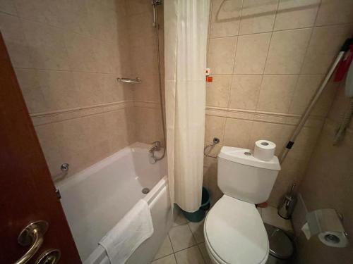 a bathroom with a toilet and a tub and a toilet paper at Nikol 3 SPA CLUB BOR in Velingrad