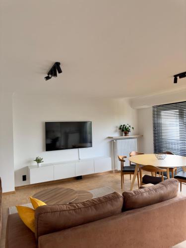 a living room with a couch and a table at Cosy apartment in Ghent in Ghent