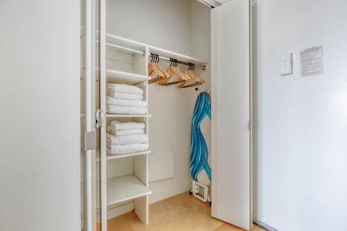 a walk in closet with white towels and shoes at FiDi studio w gym doorman nr Freedom Tower NYC-1097 in New York