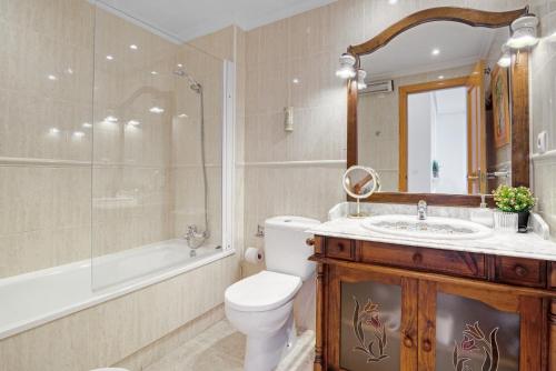 a bathroom with a toilet and a sink and a shower at Parque Mar V in La Mata