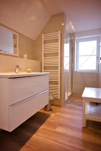 a large kitchen with a sink and a table at 1a Ferienwohnung Poel in Kirchdorf