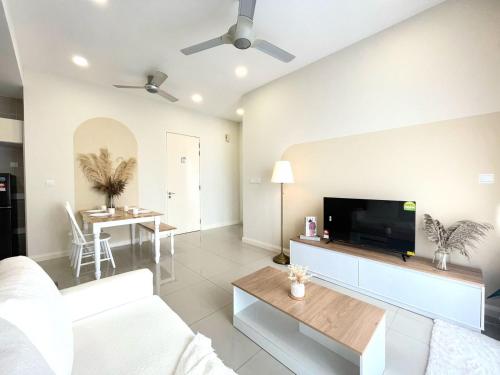 a living room with a white couch and a flat screen tv at D'pristine by Antlerzone in Johor Bahru