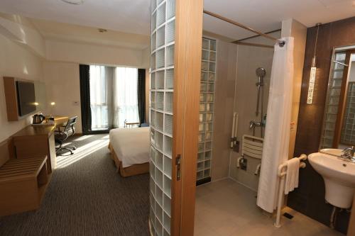 una camera d'albergo con letto e bagno di Holiday Inn Express Shanghai Jinsha, an IHG Hotel a Shanghai