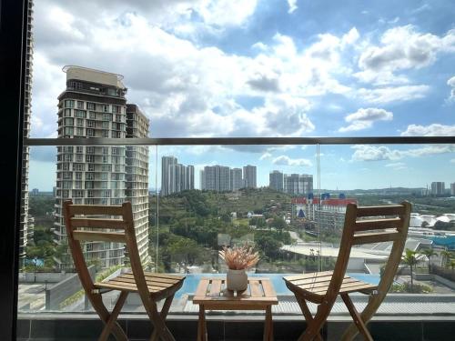 two chairs on a balcony with a view of a city at D'pristine by Antlerzone in Johor Bahru