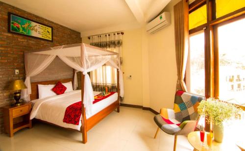 a bedroom with a bed with a canopy at Phong Nha Lake House Resort in Phong Nha
