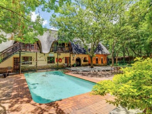 an estate with a swimming pool and a house at Lapalosa Lodge in Centurion