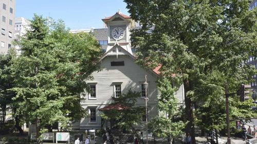 a white building with a clock tower on top of it at Toyoko Inn Hokkaido Sapporo-eki Kita-guchi in Sapporo