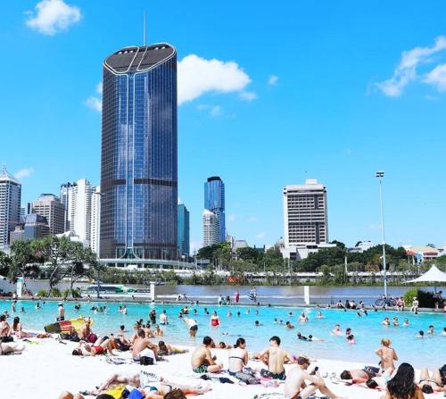 a group of people in a swimming pool in a city at Comfy Character QLD’r ~ 3Bed Self-Contained-Upstairs House w/Parking ~ Woolloongabba in Brisbane