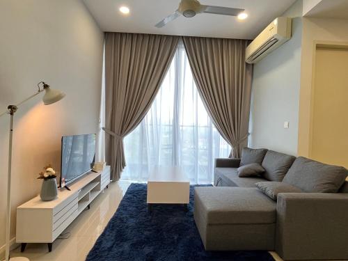 a living room with a couch and a tv at D'pristine by Antlerzone in Johor Bahru