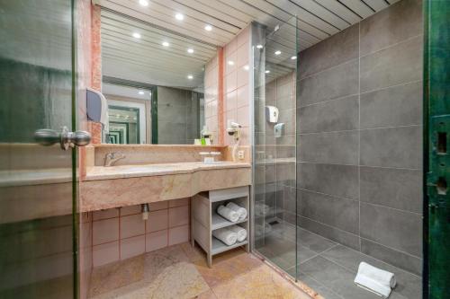a bathroom with a sink and a shower at Asteria Collection Side in Side