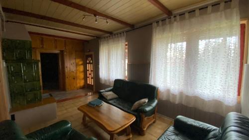 a living room with a couch and a table at Dobó Tanya in Röszke