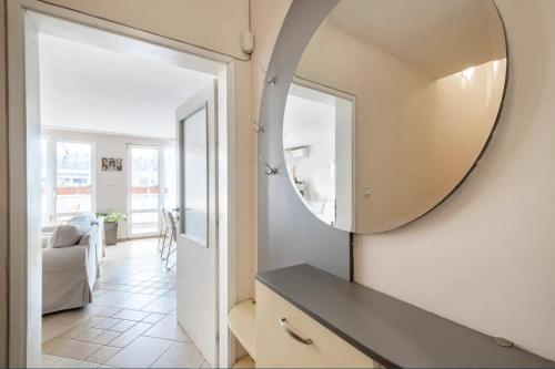 a mirror on a wall next to a living room at 2BDR Duplex Apartment with Parking in Sofia