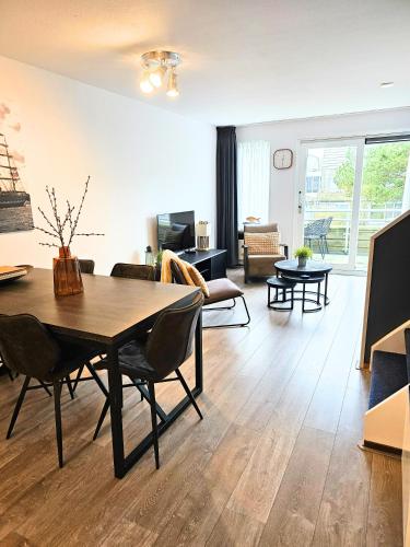 a living room with a dining table and a living room at Borndiep Amelander Kaap 34 in Hollum