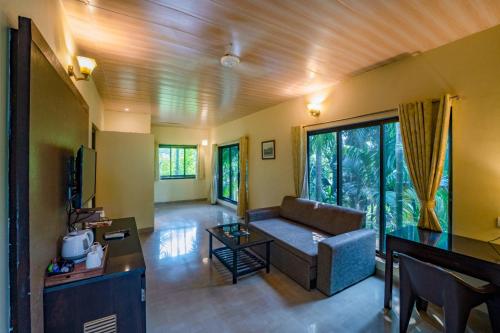 a living room with a couch and a table at Silvanus Forest Retreat, Alibaug in Alibaug
