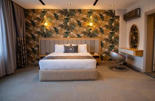 a bedroom with a large bed and a wall mural at MATEO HOTEL in Istanbul