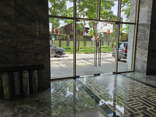a glass floor in a building with a view of a parking lot at 3BR Flat in Taman Anggrek Residence in Jakarta