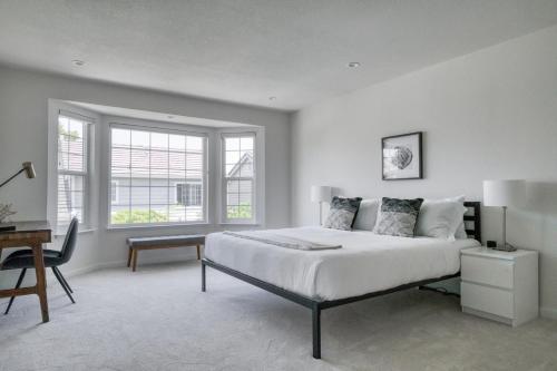 a white bedroom with a large bed and a desk at Milpitas 2br w backyard pool nr park trails SFO-1604 in Milpitas