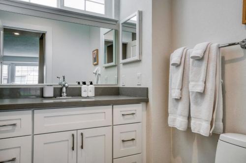 a white bathroom with a sink and a mirror at Milpitas 2br w backyard pool nr park trails SFO-1604 in Milpitas