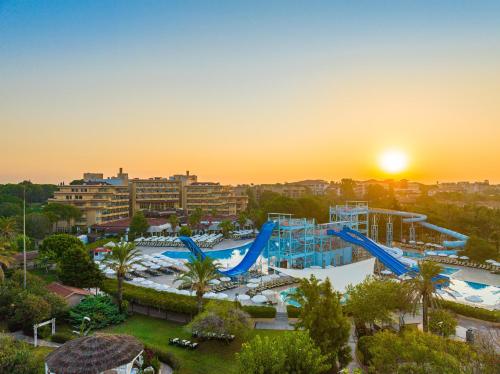 a view of a water park at sunset at Asteria Family Resort Belek in Belek